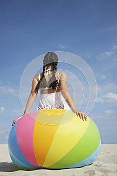 Teenage Girl Sitting On Beach Ball