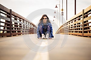 Teenage girl sitting on bridge