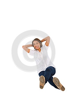 Teenage girl sitting with hands behind head