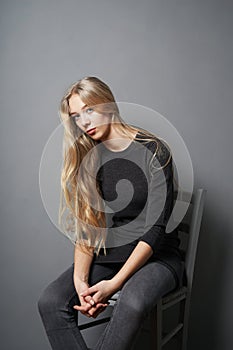 Teenage girl slouching on chair photo