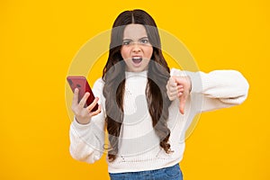 Teenage girl with smart phone. Portrait of teen child using mobile phone, cell web app. Angry face, upset emotions of