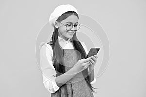 Teenage girl with smart phone. Portrait of teen child using mobile phone, cell web app. Happy face, positive and smiling
