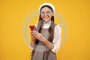 Teenage girl with smart phone. Portrait of teen child using mobile phone, cell web app. Happy face, positive and smiling