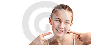 Teenage girl smiling in orthodontic brackets showing OK sign. Girl with braces on teeth