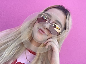 Teenage girl smiling with sunglasses and long hair