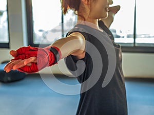 Teenage girl in sports clothes holding a dislocated shoulder on training