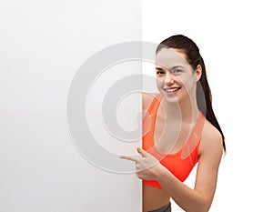 Teenage girl in sportswear with white board