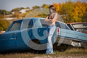 teenage girl standing next to car