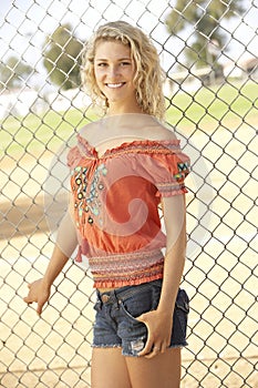 Teenage Girl Standing In Playground