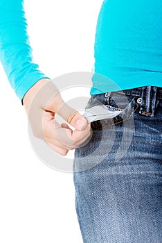 Teenage girl standing and showing her empty pockets.