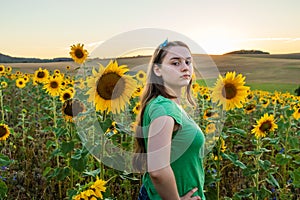 Teenage girl  standing in sunflower field