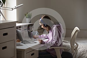 Teenage girl study distant on computer from home photo