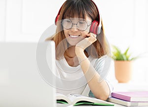 Teenage girl studying book at home