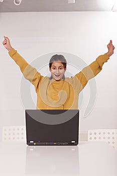 Teenage girl studying on her computer