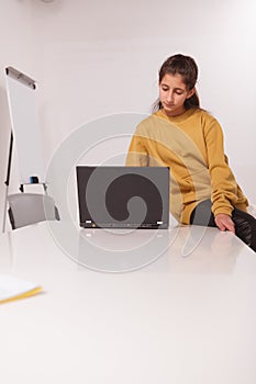 Teenage girl studying on her computer