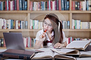 Teenage girl studying in the library