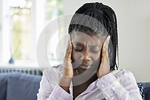 Teenage Girl Suffering With Headache At Home