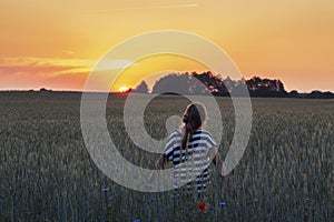 Teenage Girl on Summer Field in Warm Sunset Light