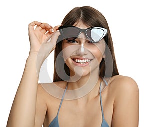 Teenage girl with sun protection cream on her nose against white background