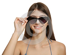 Teenage girl with sun protection cream on her nose against white background