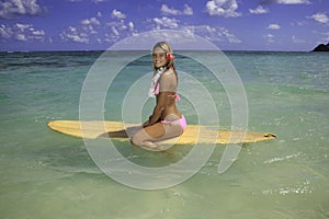 Teenage girl with surfboard