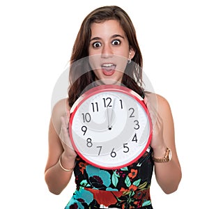Teenage girl with a surprised expression showing the time on a big clock