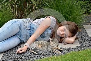 Teenage girl with tabby cat