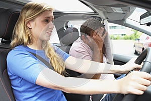 Teenage Girl Taking A Driving Lesson