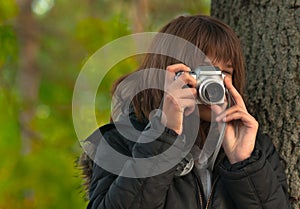 Teenage girl taking pictures with digital camera