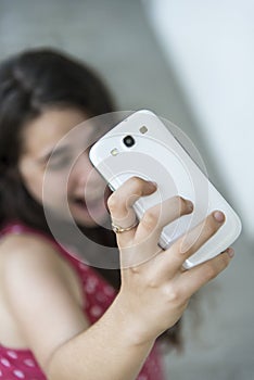 Teenage girl taking a selfie with her phone