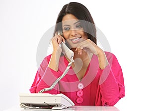 Teenage girl talking over telephone receiver