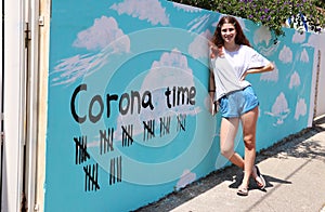 A teenage girl and a tally marks for the end of Corona`s days.