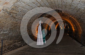 A teenage girl in the Templars tunnel in Akko, Israel