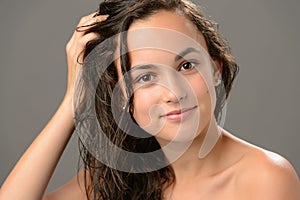 Teenage girl touch wet hair care cosmetics