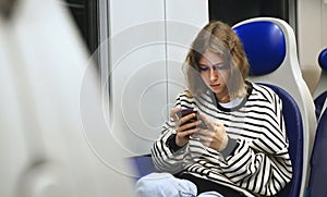 Teenage girl travelling inside the train