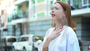 Teenage girl trying to inhale, contaminated air, big city air pollution concept