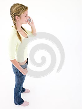 Teenage girl using cellular phone and smiling