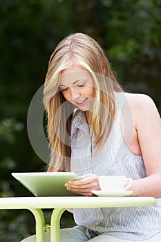 Teenage Girl Using Digital Tablet In Outdoor cafe