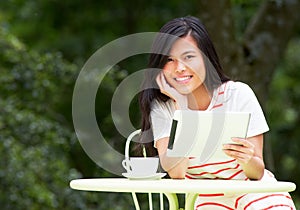 Teenage Girl Using Digital Tablet In Outdoor cafe