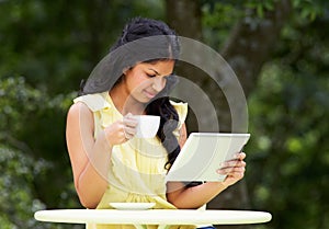 Teenage Girl Using Digital Tablet In Outdoor cafe