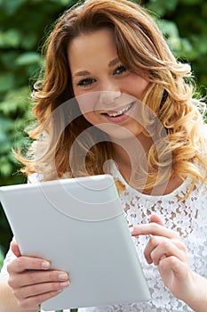 Teenage Girl Using Digital Tablet Outdoors