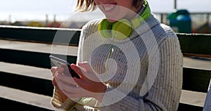 Teenage girl using mobile phone at beach 4k