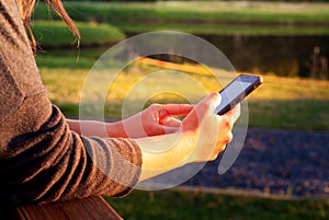 Teenage girl using mobile smart phone outdoor