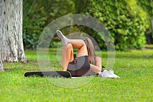 Teenage girl using smart phone while lying on grass