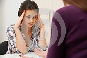 Teenage Girl Visiting Counsellor To Treat Depression photo
