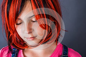 Teenage girl wanting to be like an adult dressed bright red wig