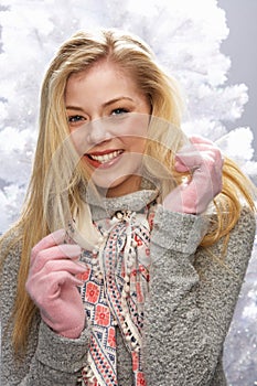 Teenage Girl Wearing Cap And Knitwear In Studio