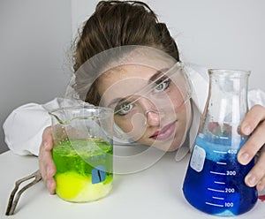 Teenage girl wearing goggles doing science experiment