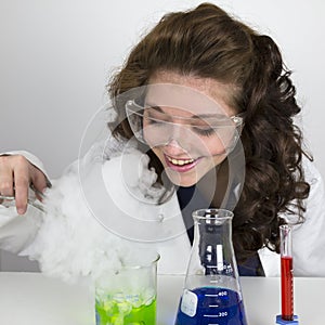 Teenage girl wearing goggles doing science experiment