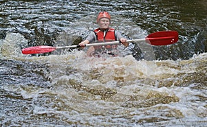 Teenage girl white water kayaking